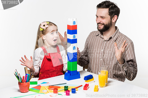 Image of Father and daughter playing educational games together 