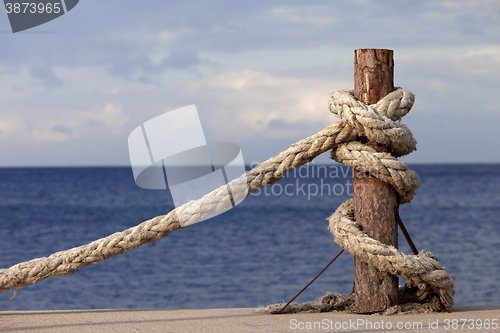 Image of Rope on seafront and cloudy sky in autumn