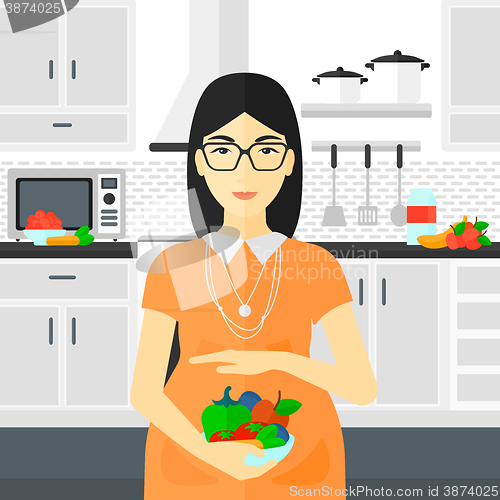 Image of Pregnant woman with vegetables.