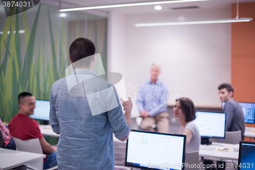 Image of student answering a question in classroom