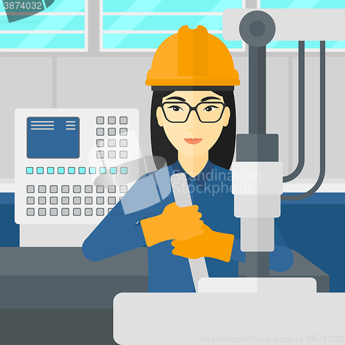 Image of Woman working with industrial equipment.