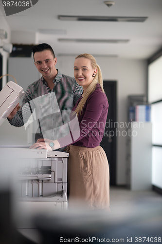 Image of business couple copy documents