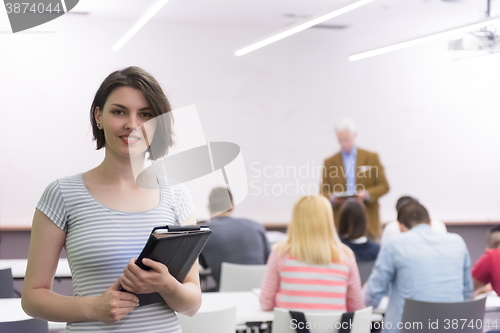 Image of portrait of happy female student in classroom