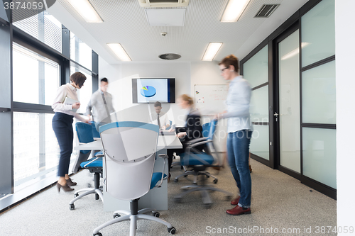 Image of business people group entering meeting room, motion blur