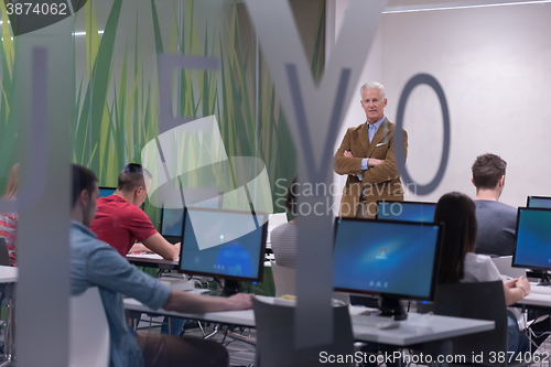 Image of teacher and students in computer lab classroom