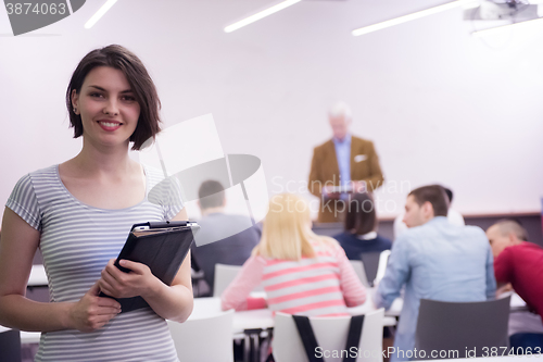 Image of portrait of happy female student in classroom