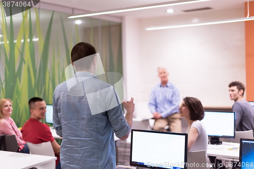 Image of student answering a question in classroom