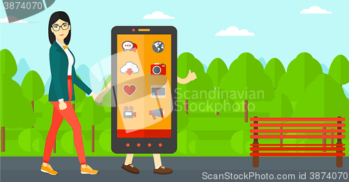 Image of Woman walking with smartphone.