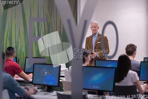 Image of teacher and students in computer lab classroom