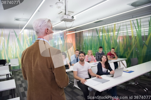 Image of teacher with a group of students in classroom