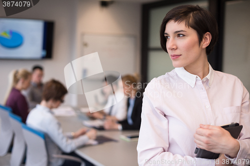 Image of hispanic businesswoman with tablet at meeting room