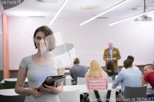 Image of portrait of happy female student in classroom