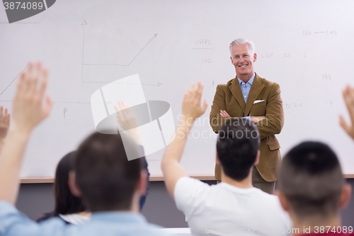 Image of teacher with a group of students in classroom