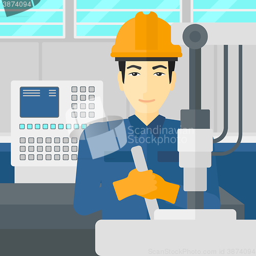 Image of Man working with industrial equipment.