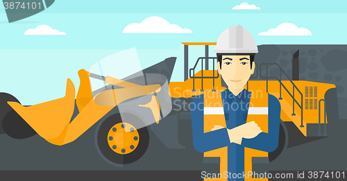 Image of Miner with mining equipment on background.