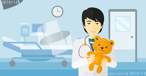 Image of Pediatrician holding teddy bear.