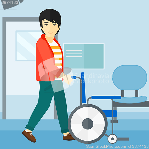 Image of Man pushing wheelchair.