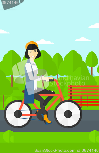 Image of Woman riding bicycle.