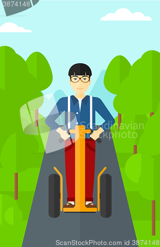 Image of Man riding on electric scooter.