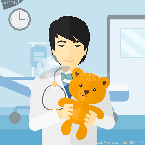 Image of Pediatrician holding teddy bear.