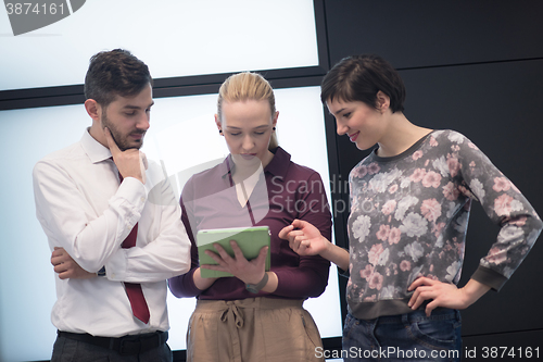 Image of young business people group working on tablet