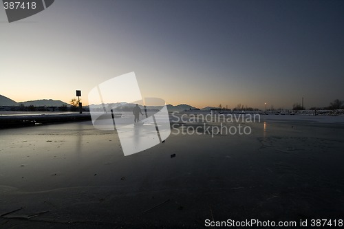 Image of Fisherman Pulling his Sled on Ice to Catch Fish