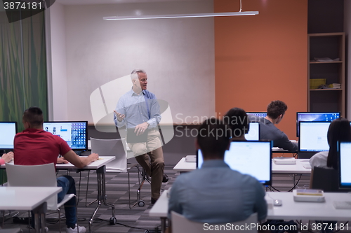 Image of teacher and students in computer lab classroom