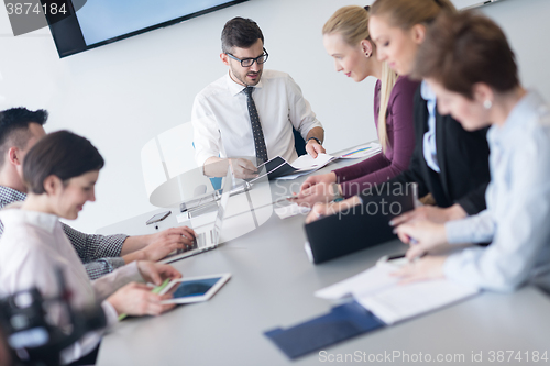 Image of young business people group on team meeting at modern office