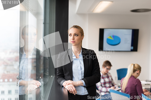 Image of portrait of young business woman at office with team on meeting 