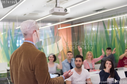 Image of teacher with a group of students in classroom