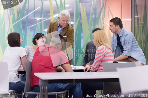 Image of teacher with a group of students in classroom