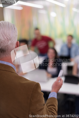 Image of teacher with a group of students in classroom