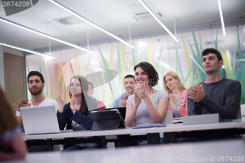 Image of teacher with a group of students in classroom