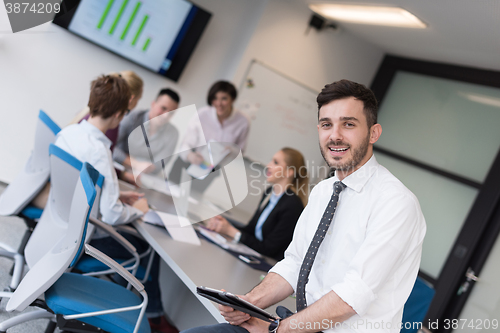 Image of young business man with tablet at office meeting room