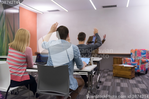 Image of teacher with a group of students in classroom