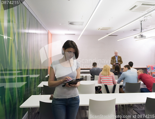 Image of portrait of happy female student in classroom