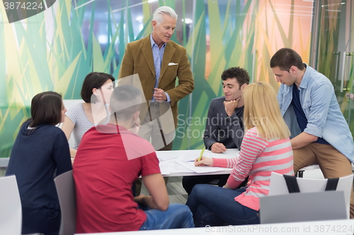 Image of teacher with a group of students in classroom