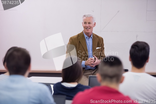 Image of teacher with a group of students in classroom