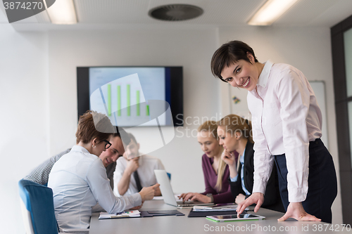 Image of young  woman using  tablet on business meeting