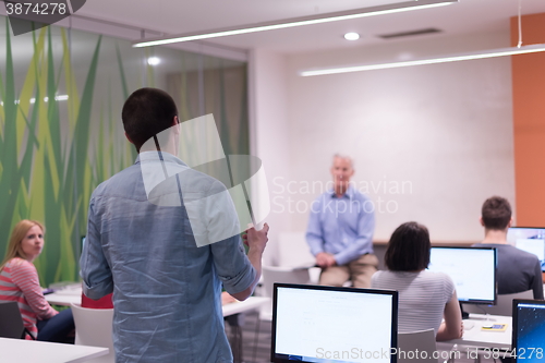 Image of student answering a question in classroom