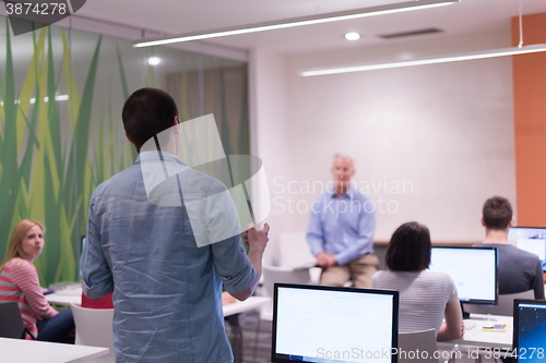 Image of student answering a question in classroom