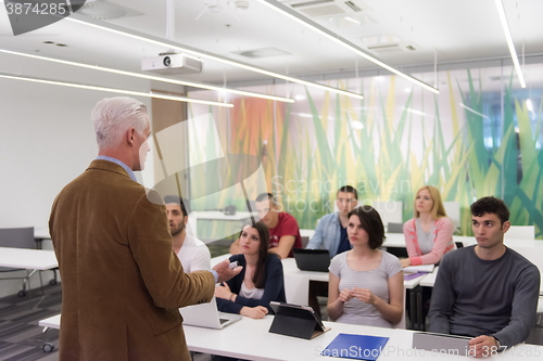 Image of teacher with a group of students in classroom