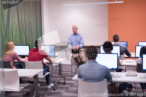 Image of teacher and students in computer lab classroom