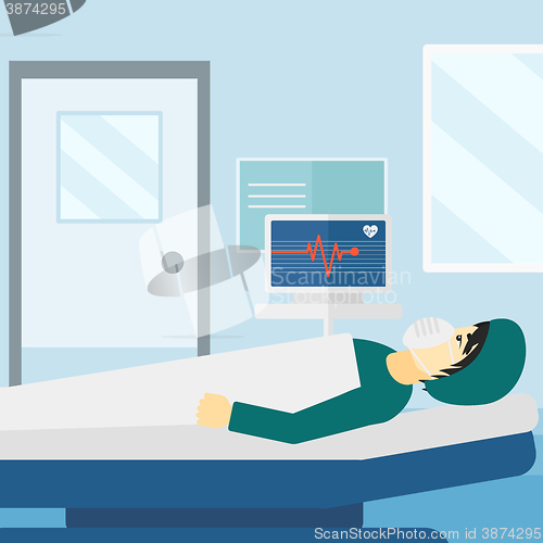 Image of Patient lying in hospital  bed with heart monitor.