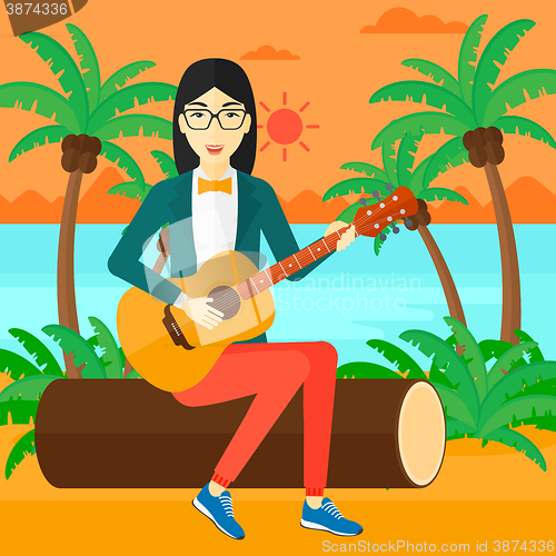 Image of Woman playing guitar.