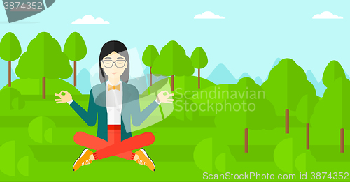 Image of Business woman meditating in lotus pose.