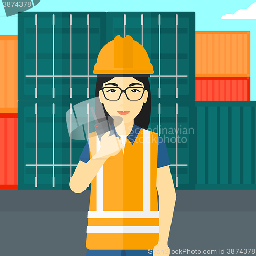 Image of Stevedore standing on cargo containers background.