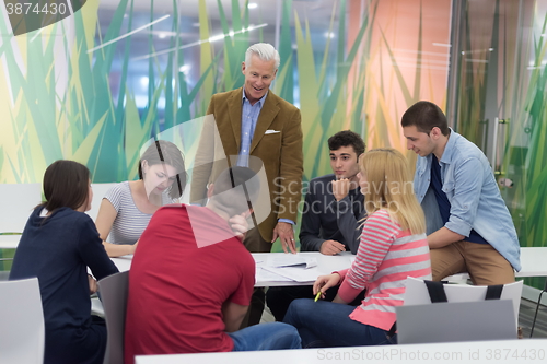 Image of teacher with a group of students in classroom