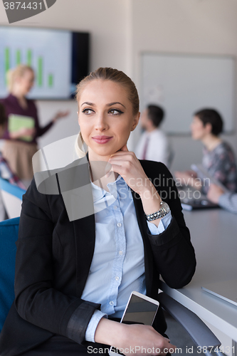 Image of portrait of young business woman at office with team on meeting 