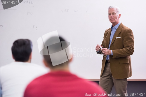 Image of teacher with a group of students in classroom